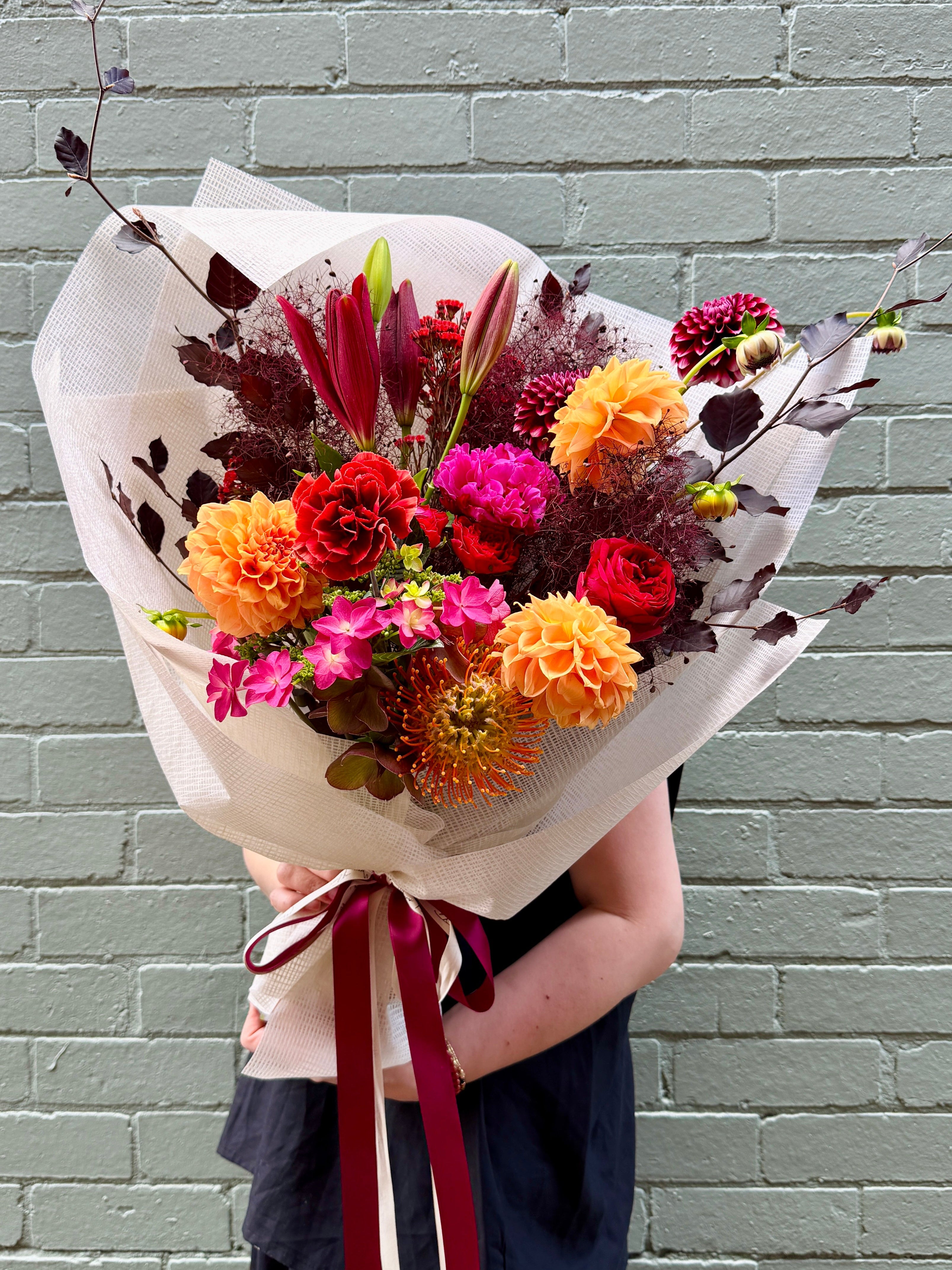 Florist's choice with seasonal flowers in Burgandy/red&orange