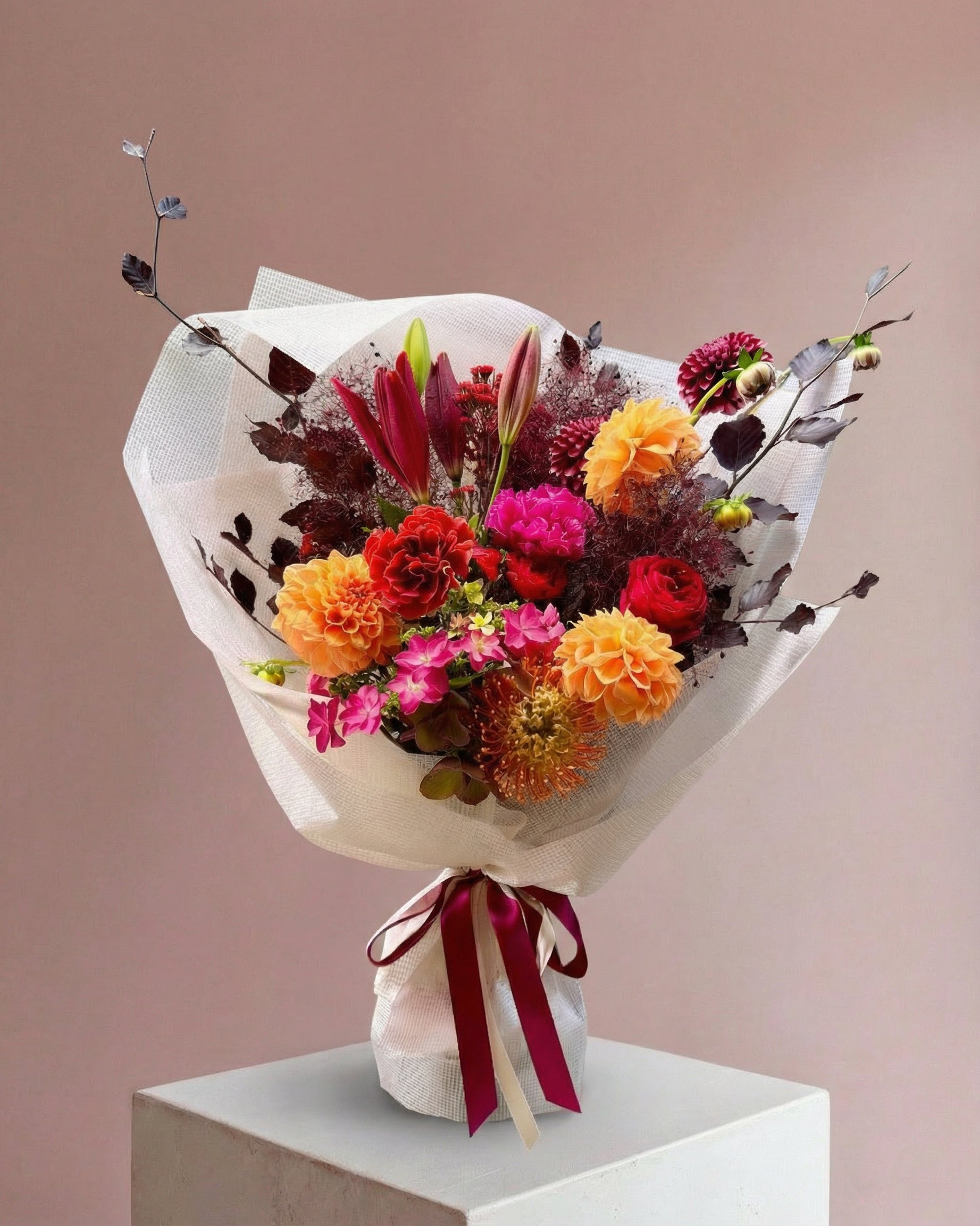 Florist's choice with seasonal flowers in Burgandy/red&orange
